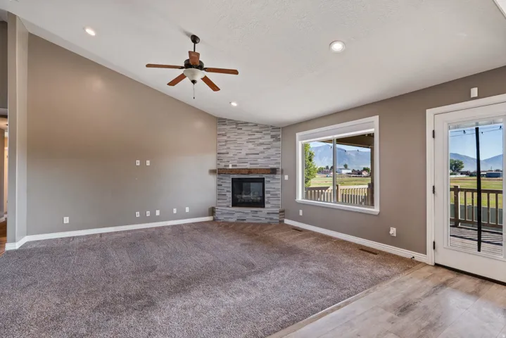 Vaulted ceiling with recessed lighting and a ceiling fan