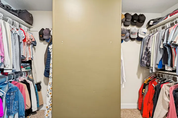 Walk-in closet featuring wire shelving and hanging rods