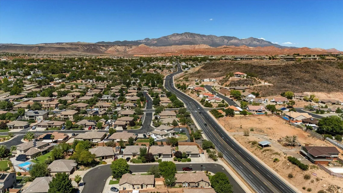 Residential neighborhood with extensive landscaping and a prominent roadway