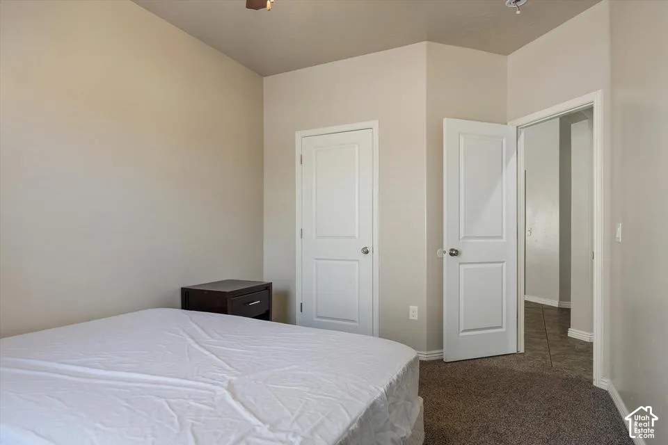 Carpeted flooring with light-toned walls, and white paneled doors