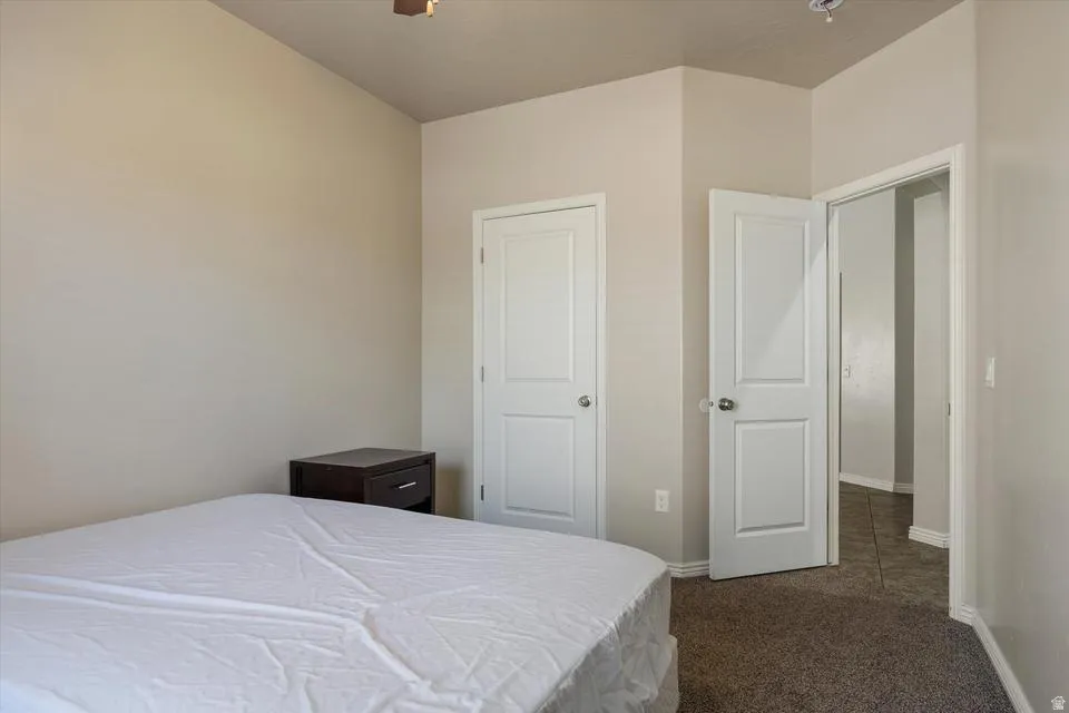 Carpeted flooring with light-toned walls, and white paneled doors