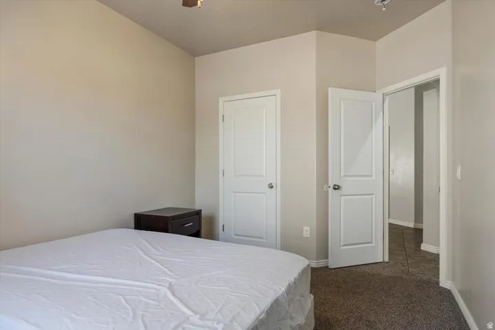 Carpeted flooring with light-toned walls, and white paneled doors