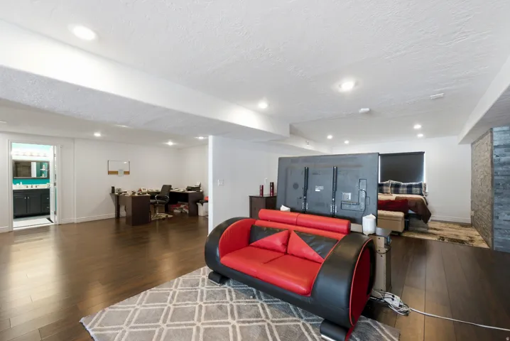 Wood-finish flooring throughout, recessed lighting, and white walls