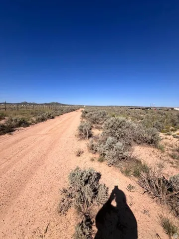 Expansive open terrain with a clear sky and natural vegetation