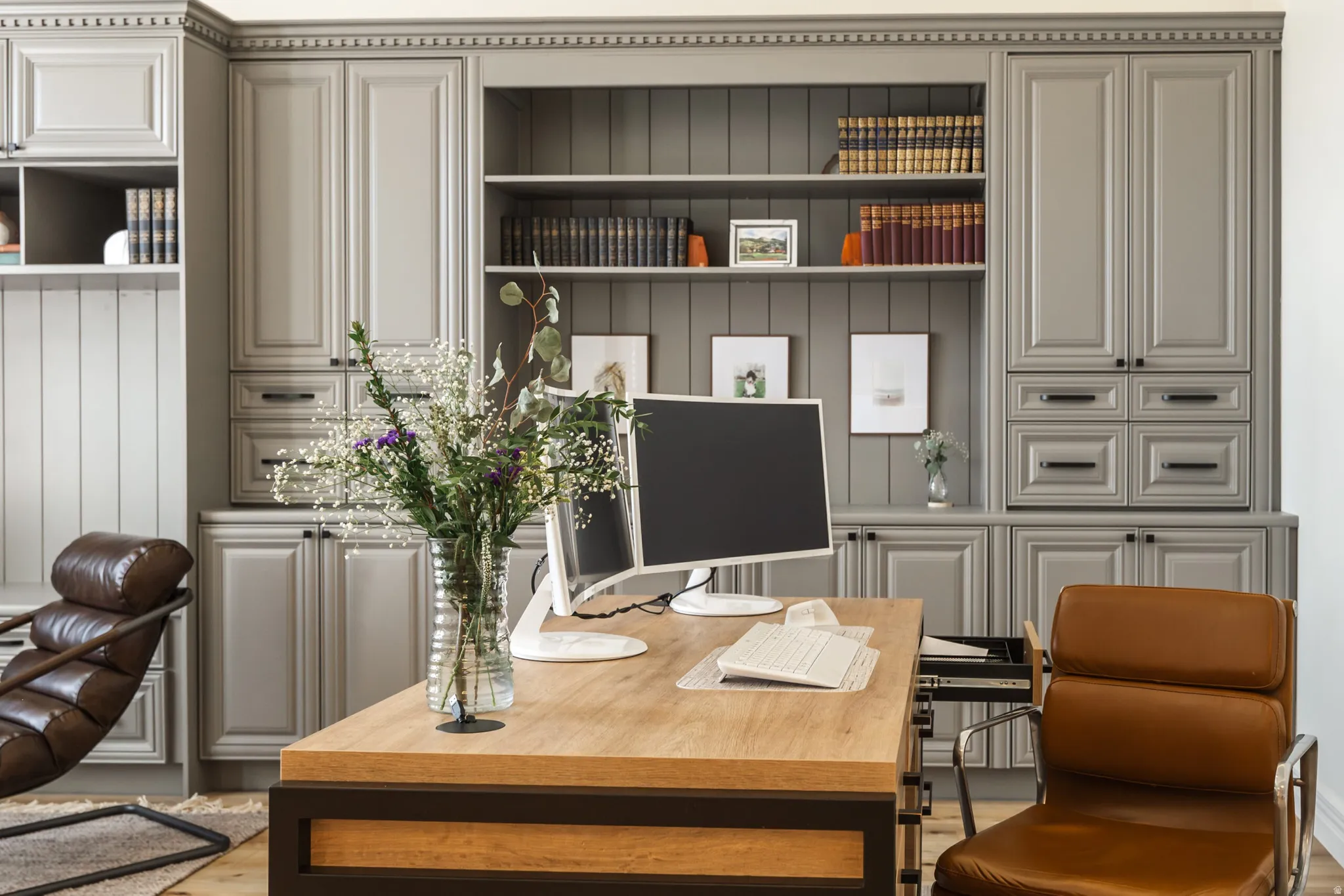 Custom built-in cabinetry with crown molding and fluted pilasters