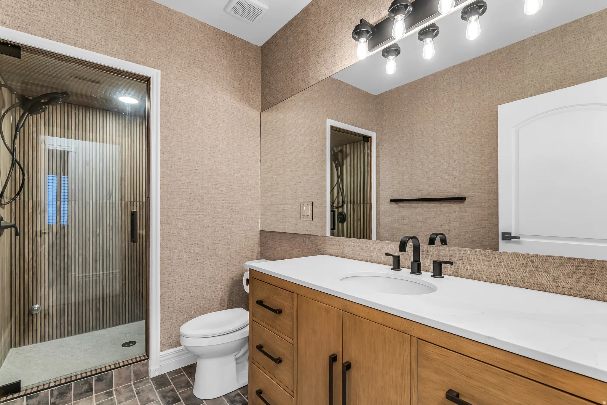 Glass-enclosed shower with vertical plank wall tile