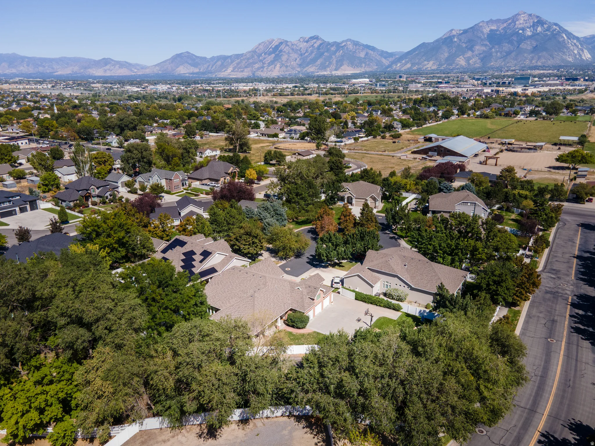 Aerial perspective showcasing the surrounding residential area and distant mountain range