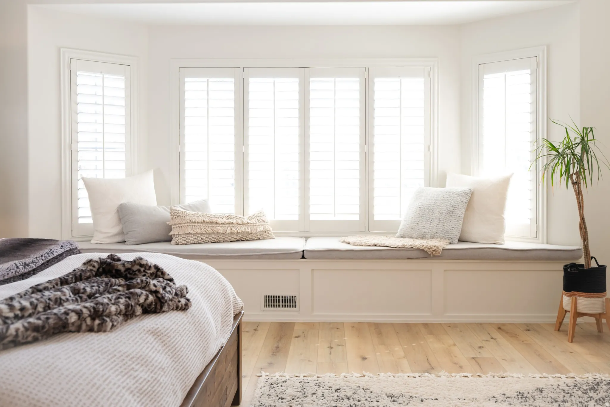 Bay window with built-in bench seating and panel shutters