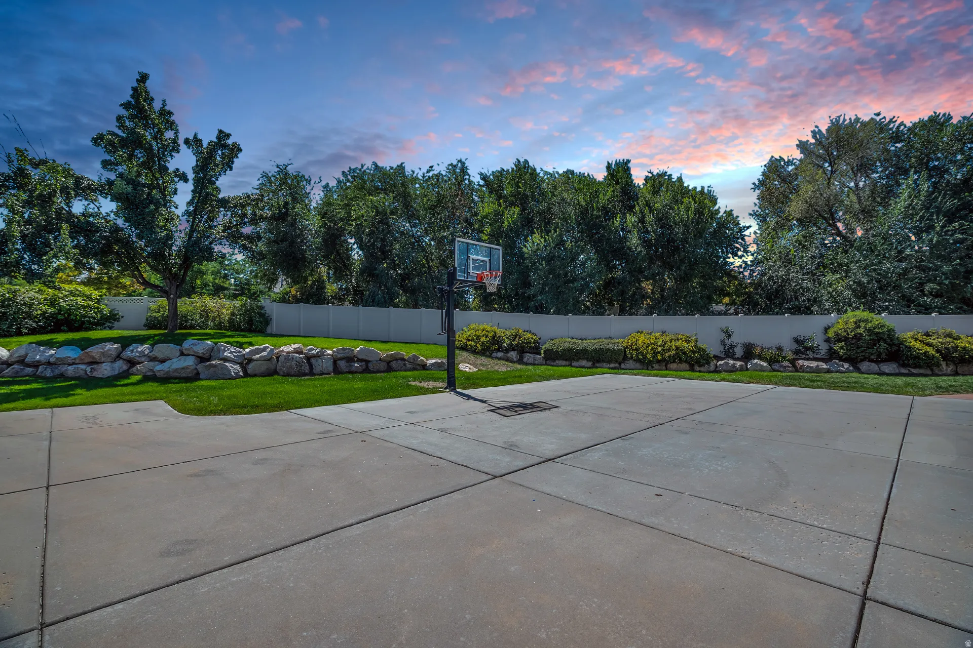 Expansive concrete sports court with a basketball hoop