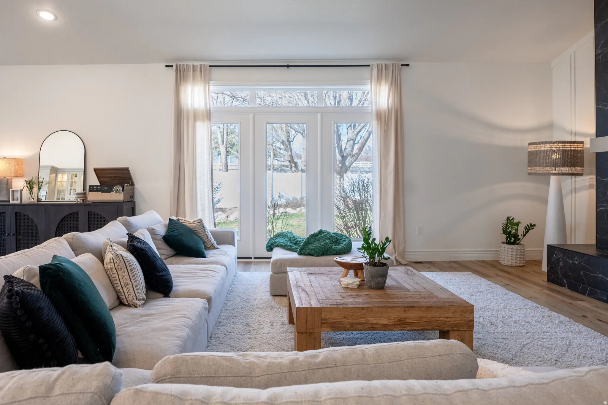 White walls paired with warm wood-finish flooring