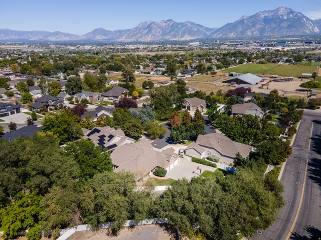Aerial perspective showcasing the surrounding residential area and distant mountain range