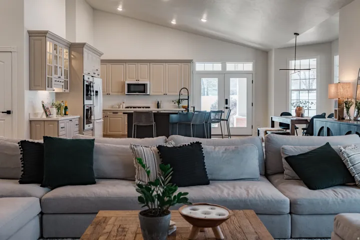 Vaulted ceilings, recessed lighting, double ovens, and a kitchen island with seating