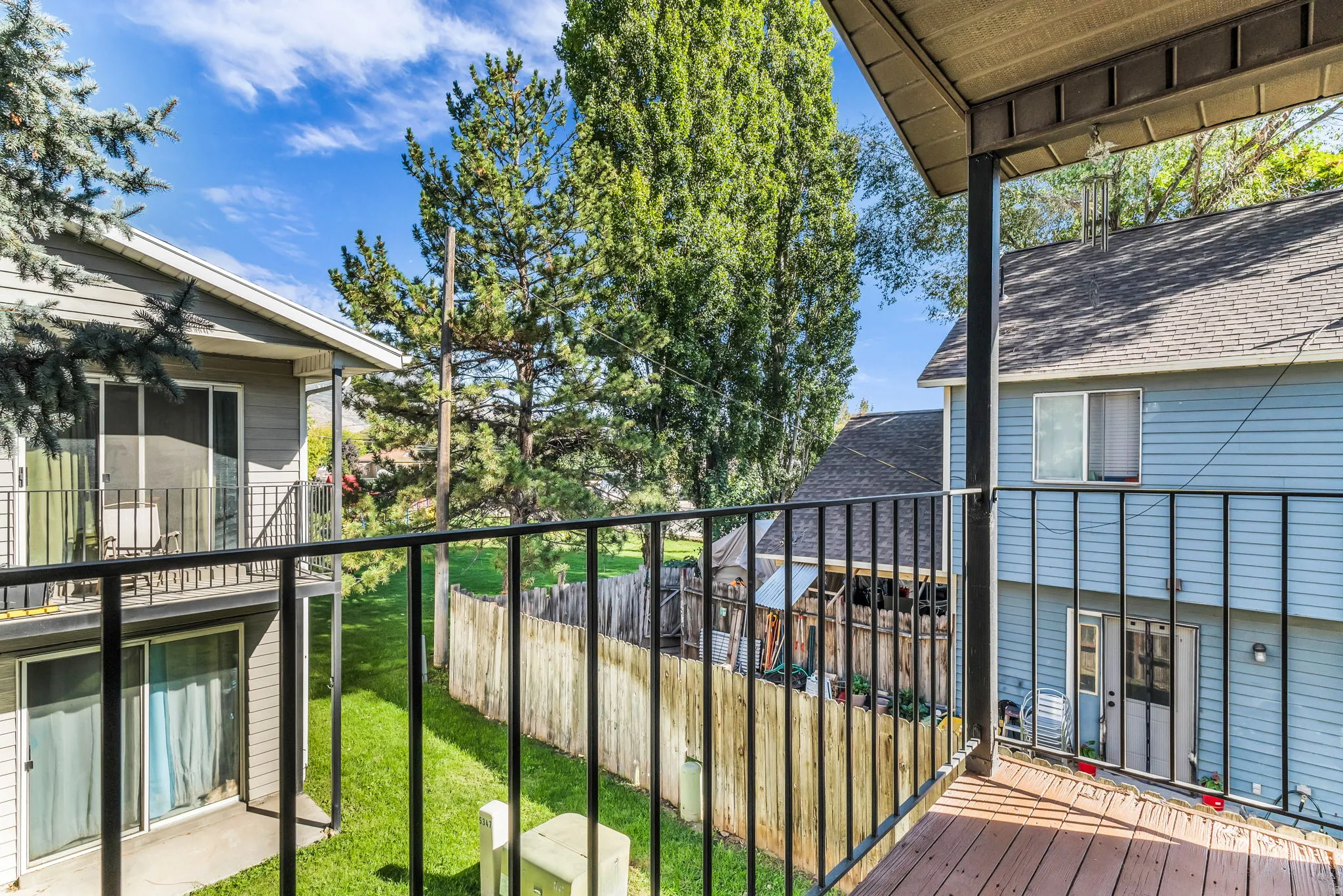 Balcony with black metal railings and wood-finish flooring