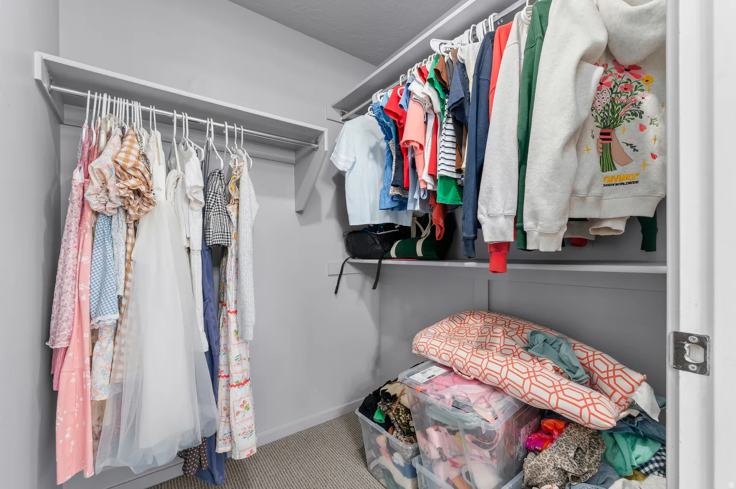 Walk-in closet featuring built-in shelving and hanging rods