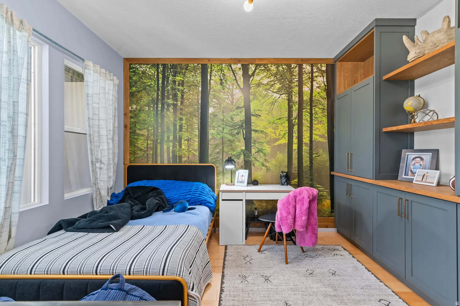 Built-in cabinetry with open shelving, wood-finish countertops, and a wood-finish accent wall