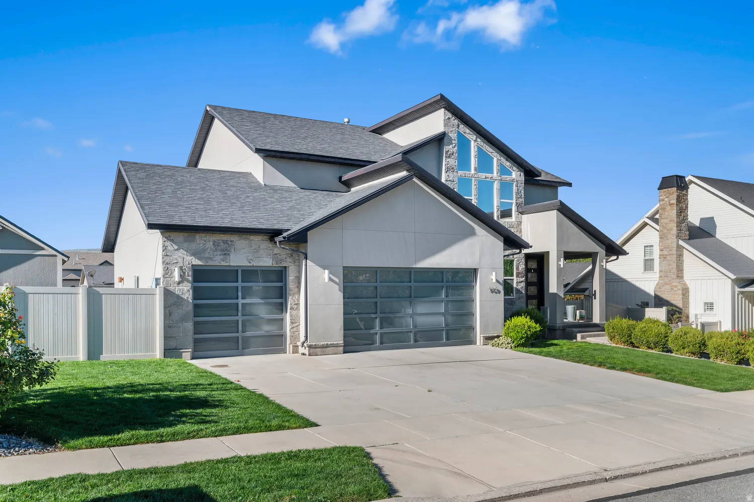 Stone veneer and stucco exterior with multiple gables