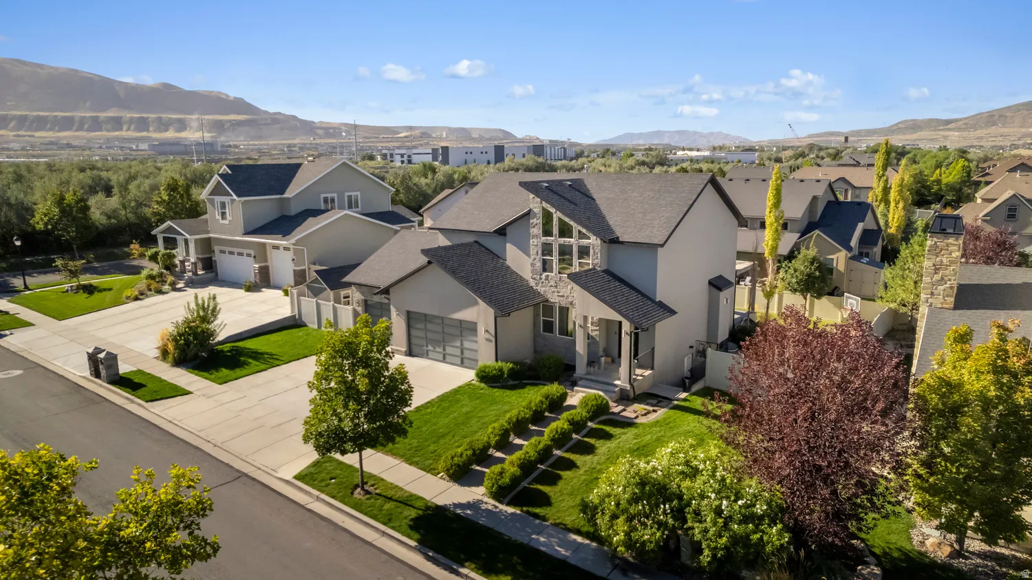 Contemporary architecture with a multi-gabled roofline and stone accents