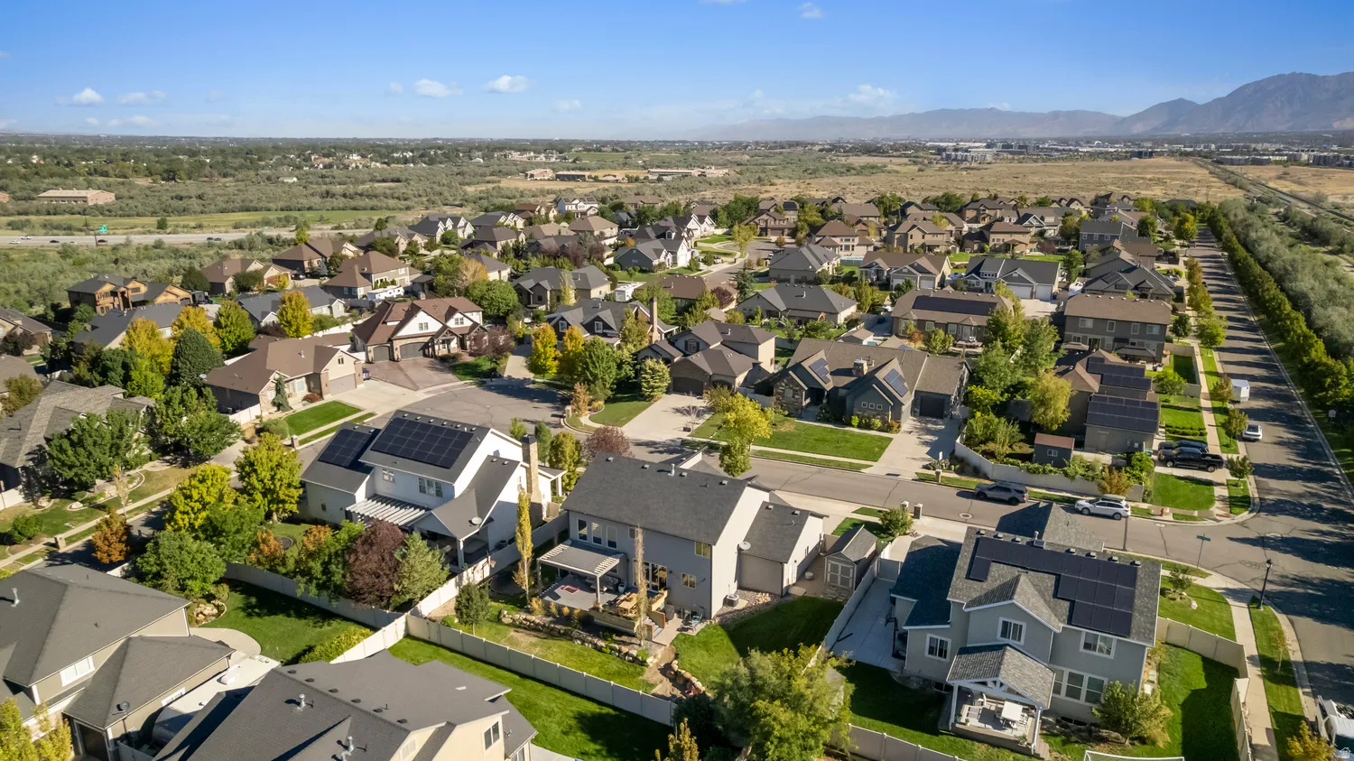 Spacious residential community featuring diverse architectural styles, mature landscaping, and an organized street layout