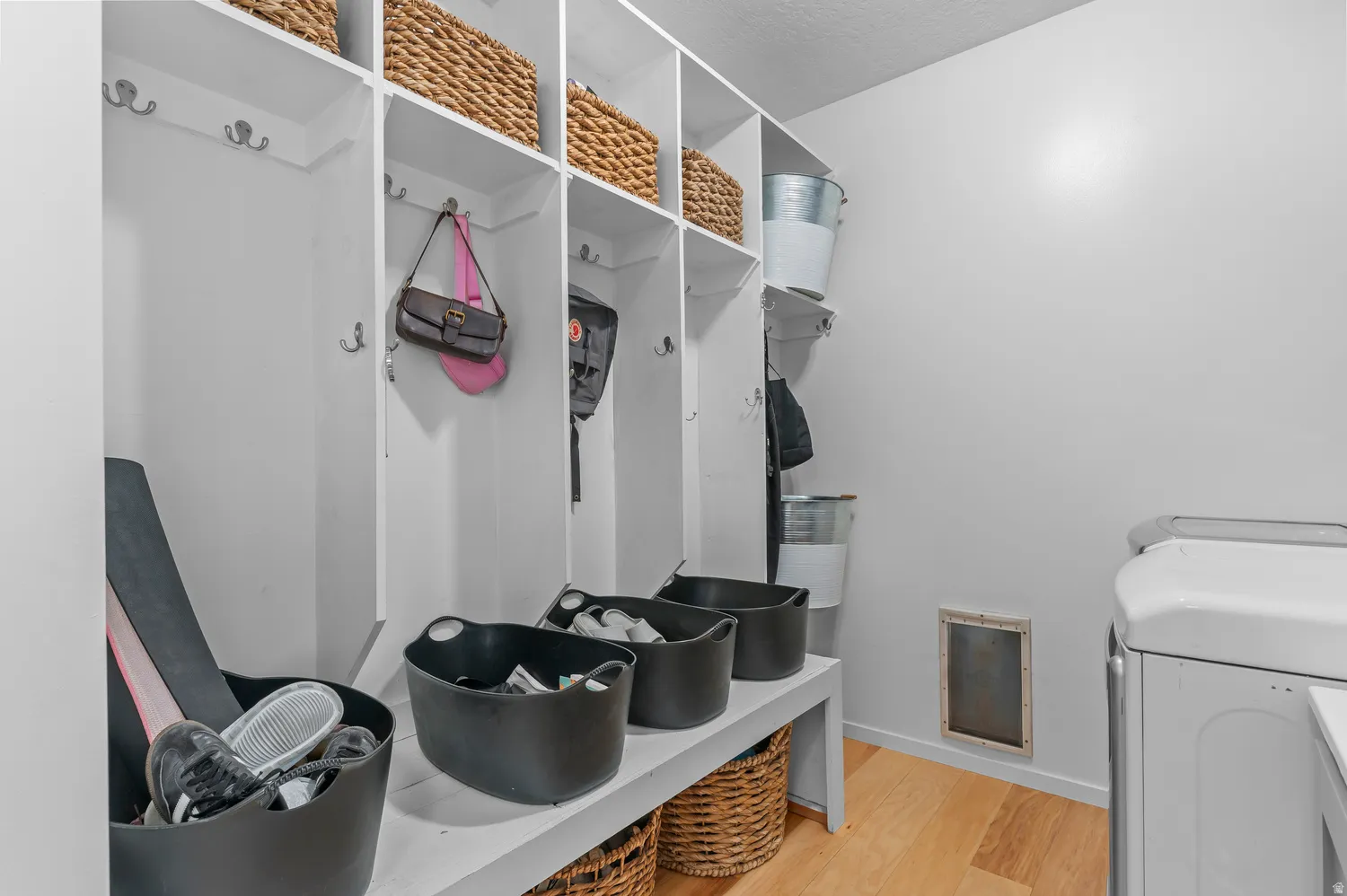 Built-in storage cubbies with white finishes and integrated hooks