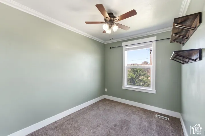 Wall-to-wall carpeting with a ceiling fan light fixture