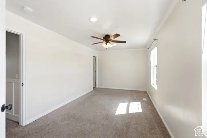 Carpeted room featuring crown molding, a ceiling fan with integrated lighting, and recessed lighting
