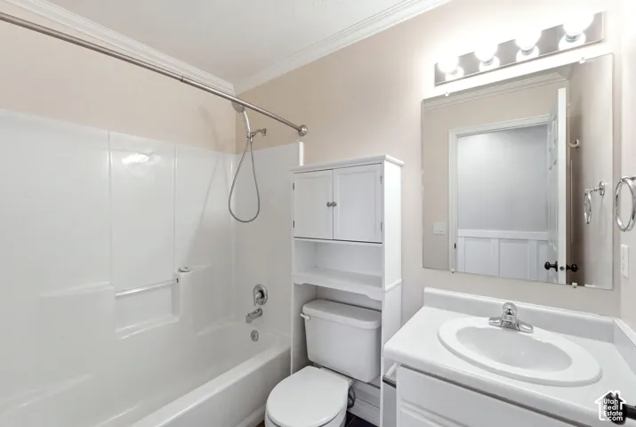 White vanity with integrated sink, chrome faucet, and rectangular mirror