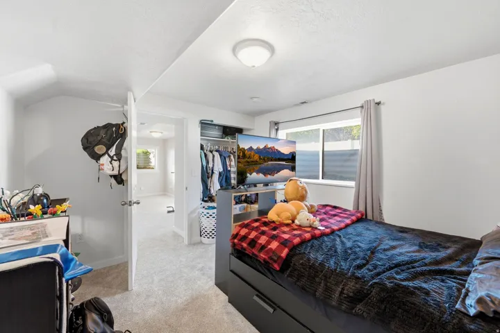 Wall-to-wall carpeting throughout, white painted walls, and an overhead flush mount light fixture