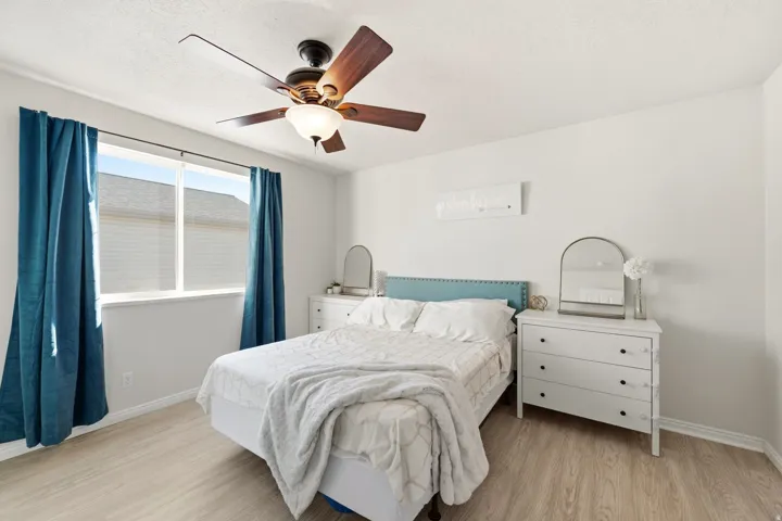 Light wood-finish flooring with white walls