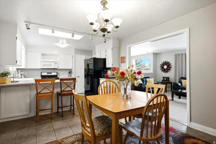Kitchen featuring white cabinetry, a skylight, and a breakfast bar