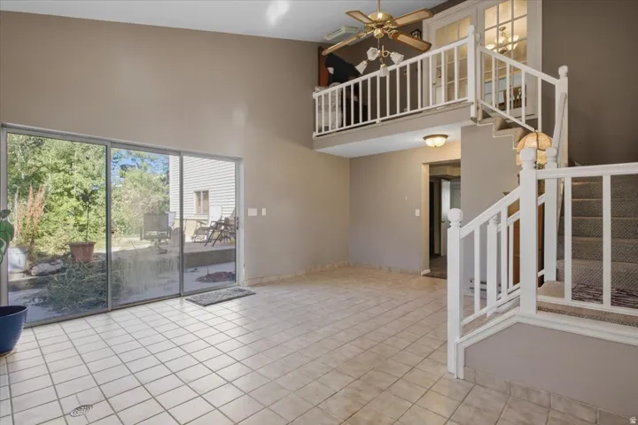 Expansive living area with vaulted ceilings and ceramic tile flooring
