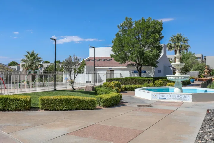 Landscaped courtyard featuring a multi-tiered fountain and surrounding green spaces