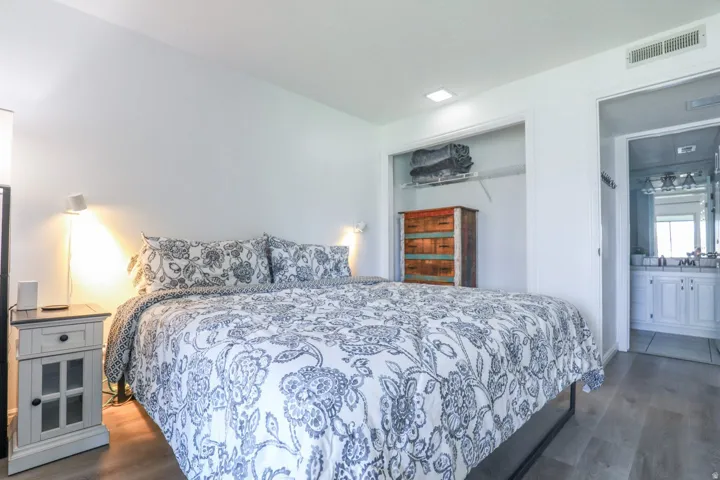 Light wood-finish flooring, recessed lighting, and a closet with wire shelving