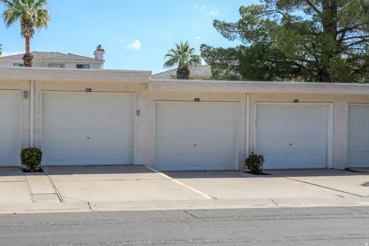 Attached garages with white panel doors and exterior wall sconces