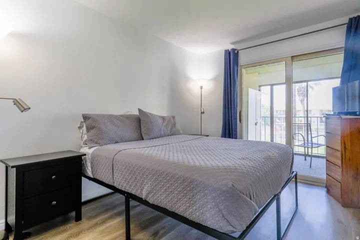 Bright room with wood-finish flooring and direct access to a private balcony