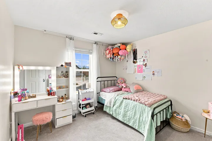 Recessed ceiling lighting, ceiling-mounted light fixture, window with blinds and sheer curtains, and textured carpet flooring