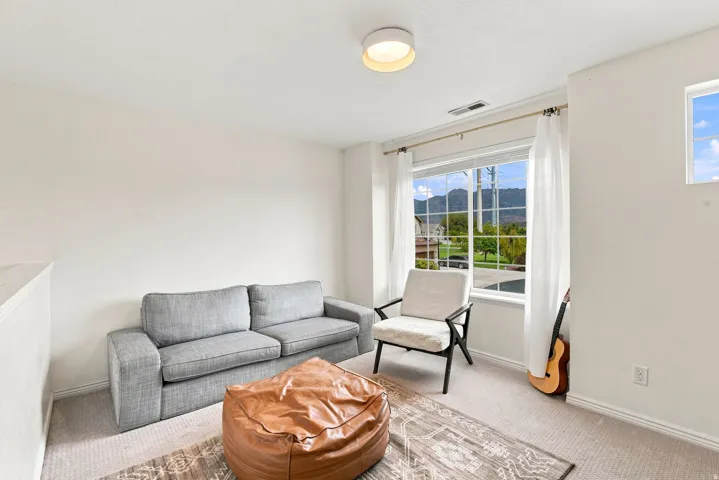 Carpeted flooring, recessed window, ceiling-mounted light fixture, and neutral wall tones