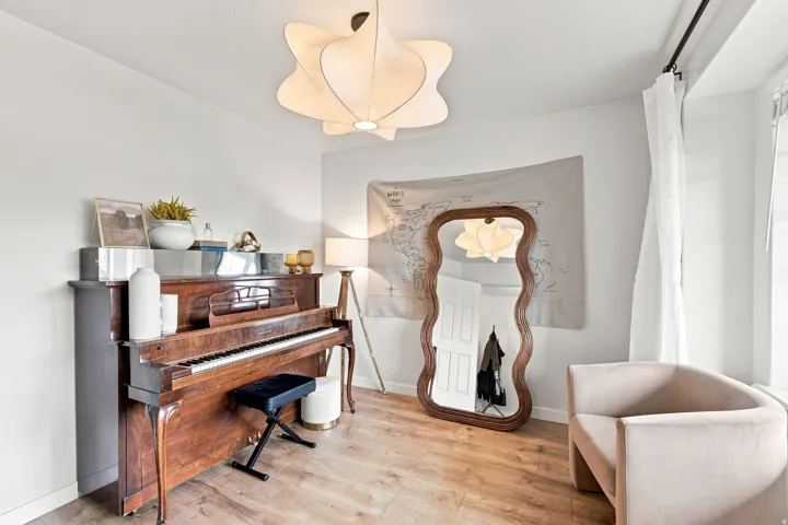 Wood-finish flooring, white walls, and a contemporary ceiling light fixture