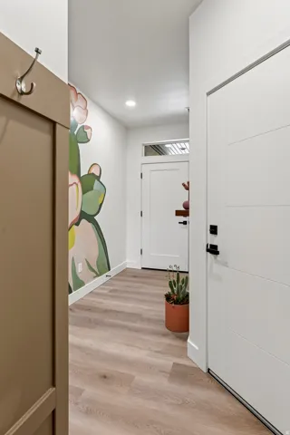 Light wood-finish flooring extending through the hallway