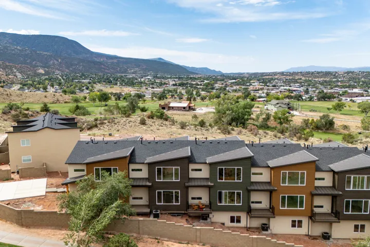 Modern townhome exteriors featuring multi-toned siding and dark pitched roofs