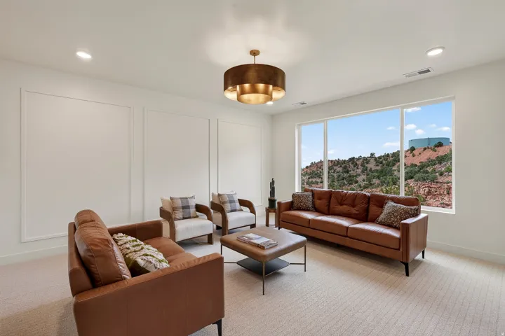 Expansive window with a mountain backdrop, decorative wall paneling, recessed lighting, and a drum-style ceiling fixture