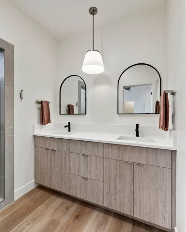 Double vanity with wood-finish cabinetry and white countertops