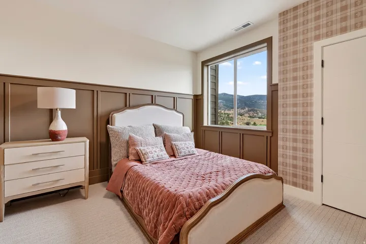 Wall paneling details, large picture window, patterned accent wall, carpeted flooring, and a flat-panel door