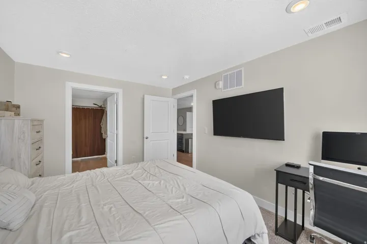 Recessed ceiling lighting, carpet flooring, and painted walls