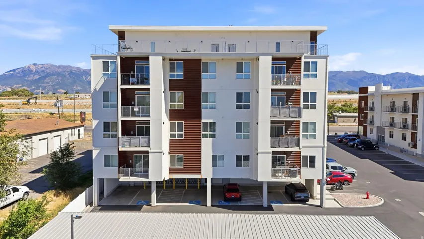 Contemporary multi-story building featuring balconies with glass railings