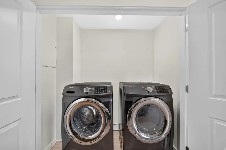 Dedicated laundry area featuring a flush-mount ceiling light and white panel doors