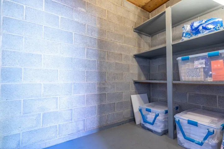 Concrete block wall construction, wood ceiling, and built-in shelving