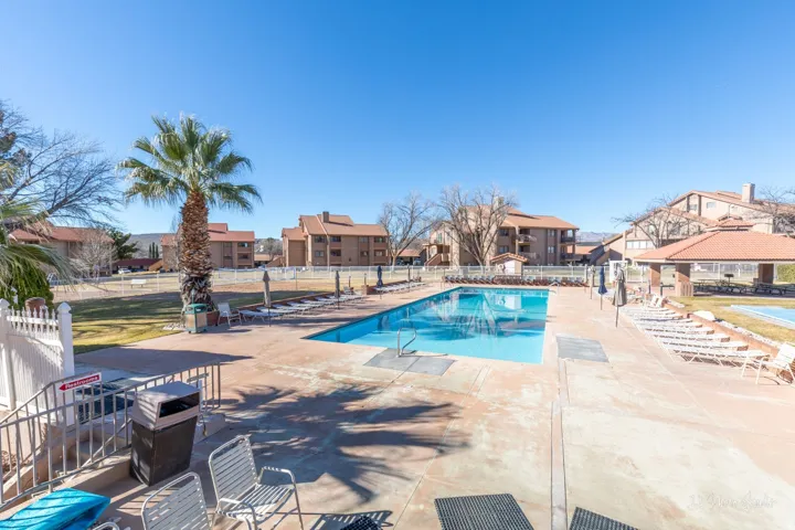 Outdoor swimming pool with integrated steps, surrounded by a concrete deck