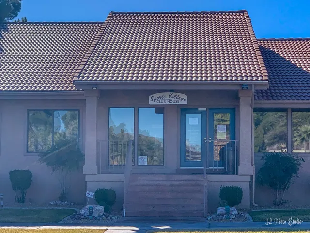 Clubhouse entrance featuring a tiled roof and multiple windows
