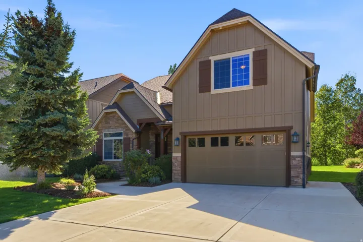 Craftsman-style exterior with stone accents, board and batten siding, and a gabled roofline