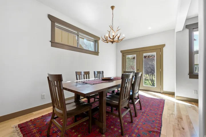 Hardwood flooring, white walls, and wood trim